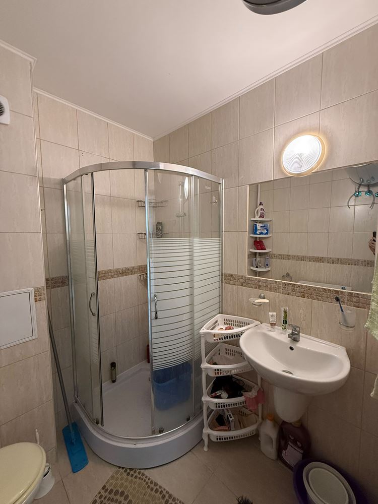 One-bedroom apartment surrounded by greenery in a complex with a swimming pool and children's playground