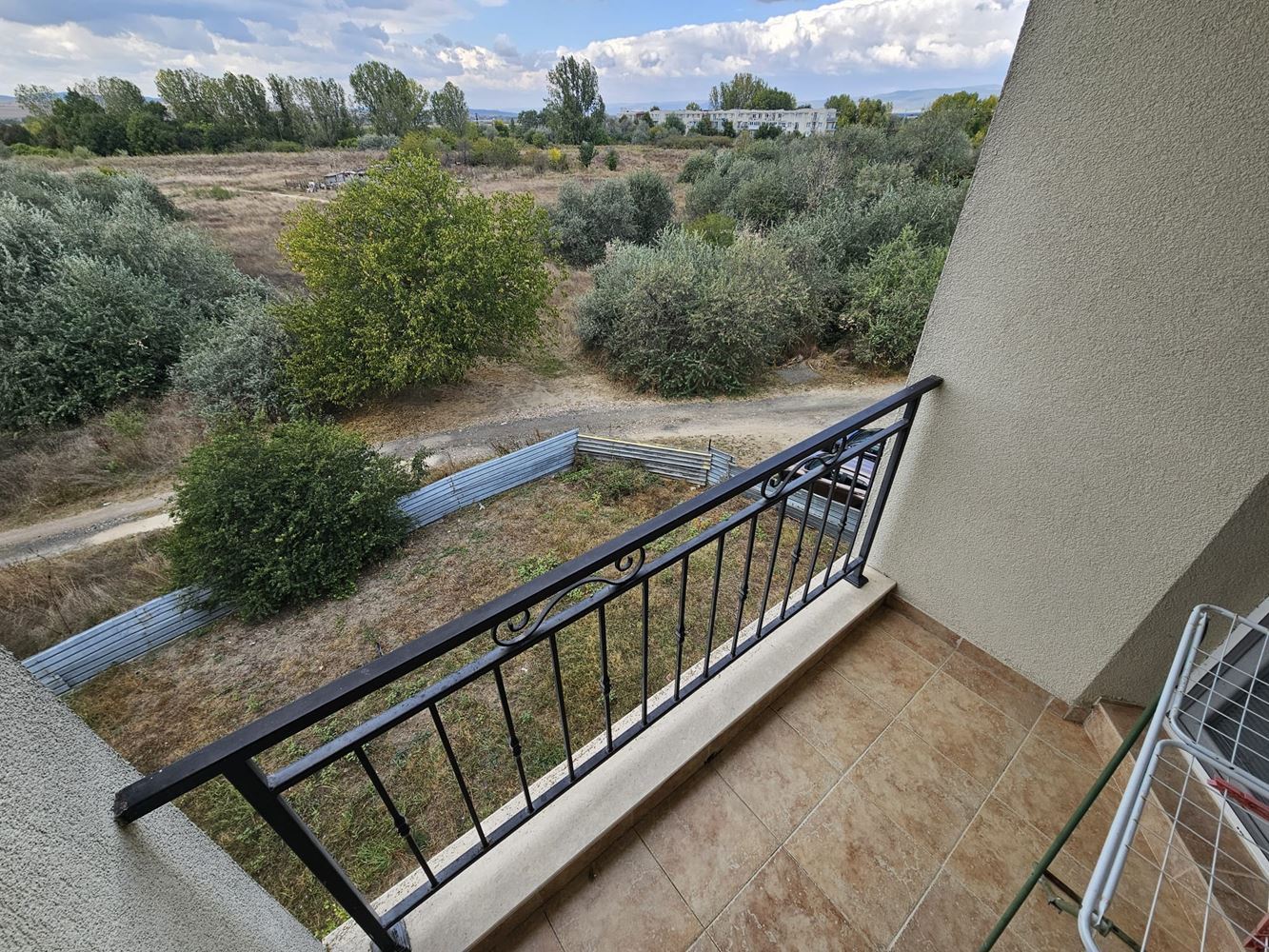 One-bedroom apartment surrounded by greenery in a complex with a swimming pool and children's playground