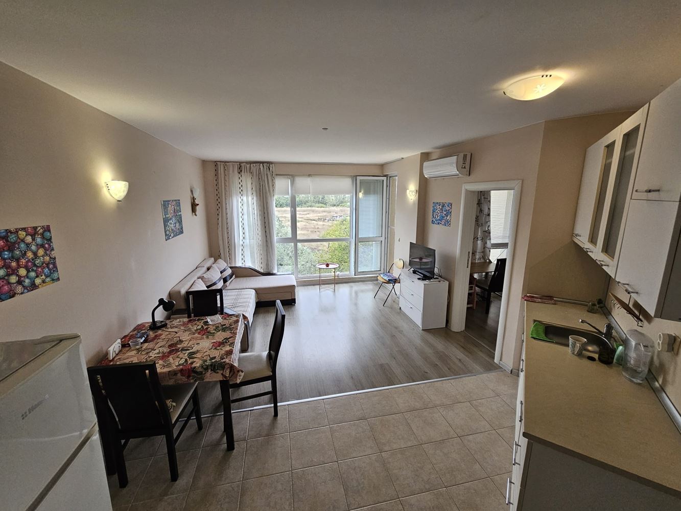 One-bedroom apartment surrounded by greenery in a complex with a swimming pool and children's playground