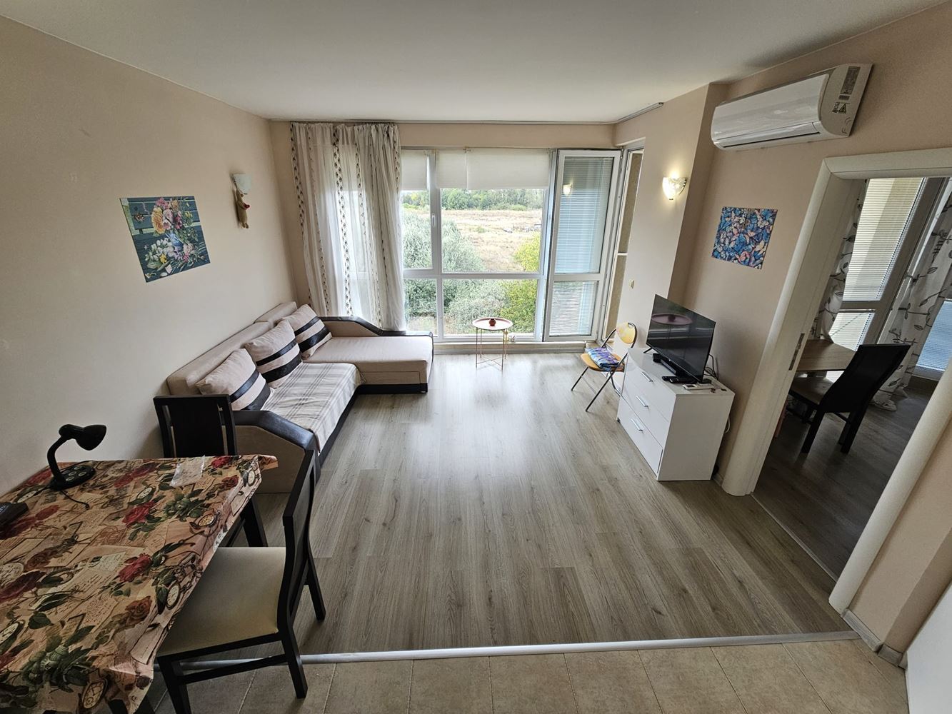 One-bedroom apartment surrounded by greenery in a complex with a swimming pool and children's playground