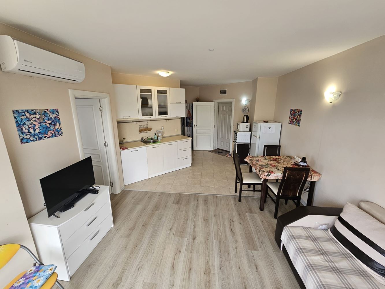 One-bedroom apartment surrounded by greenery in a complex with a swimming pool and children's playground