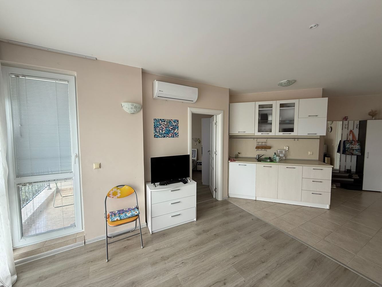 One-bedroom apartment surrounded by greenery in a complex with a swimming pool and children's playground