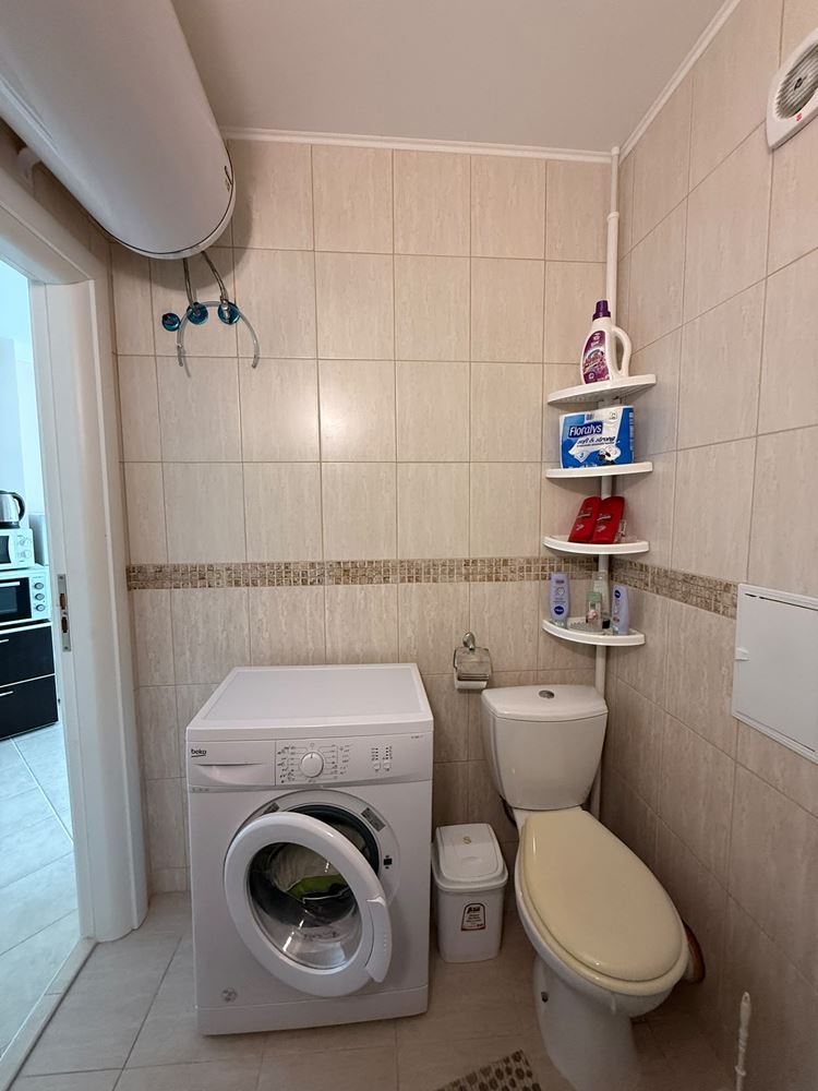 One-bedroom apartment surrounded by greenery in a complex with a swimming pool and children's playground