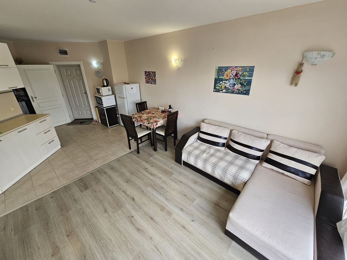 One-bedroom apartment surrounded by greenery in a complex with a swimming pool and children's playground