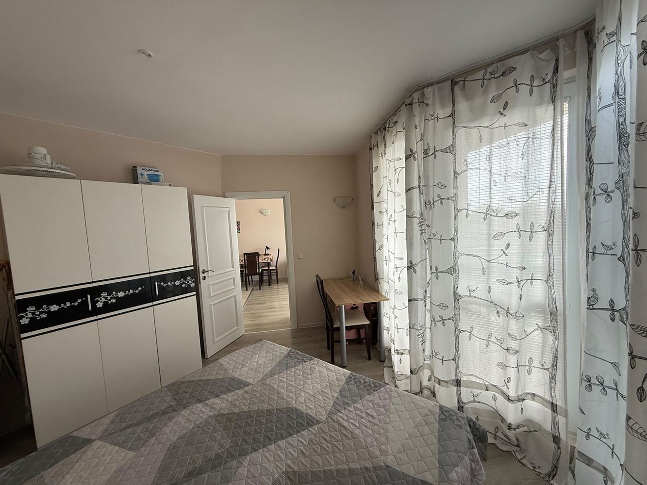 One-bedroom apartment surrounded by greenery in a complex with a swimming pool and children's playground