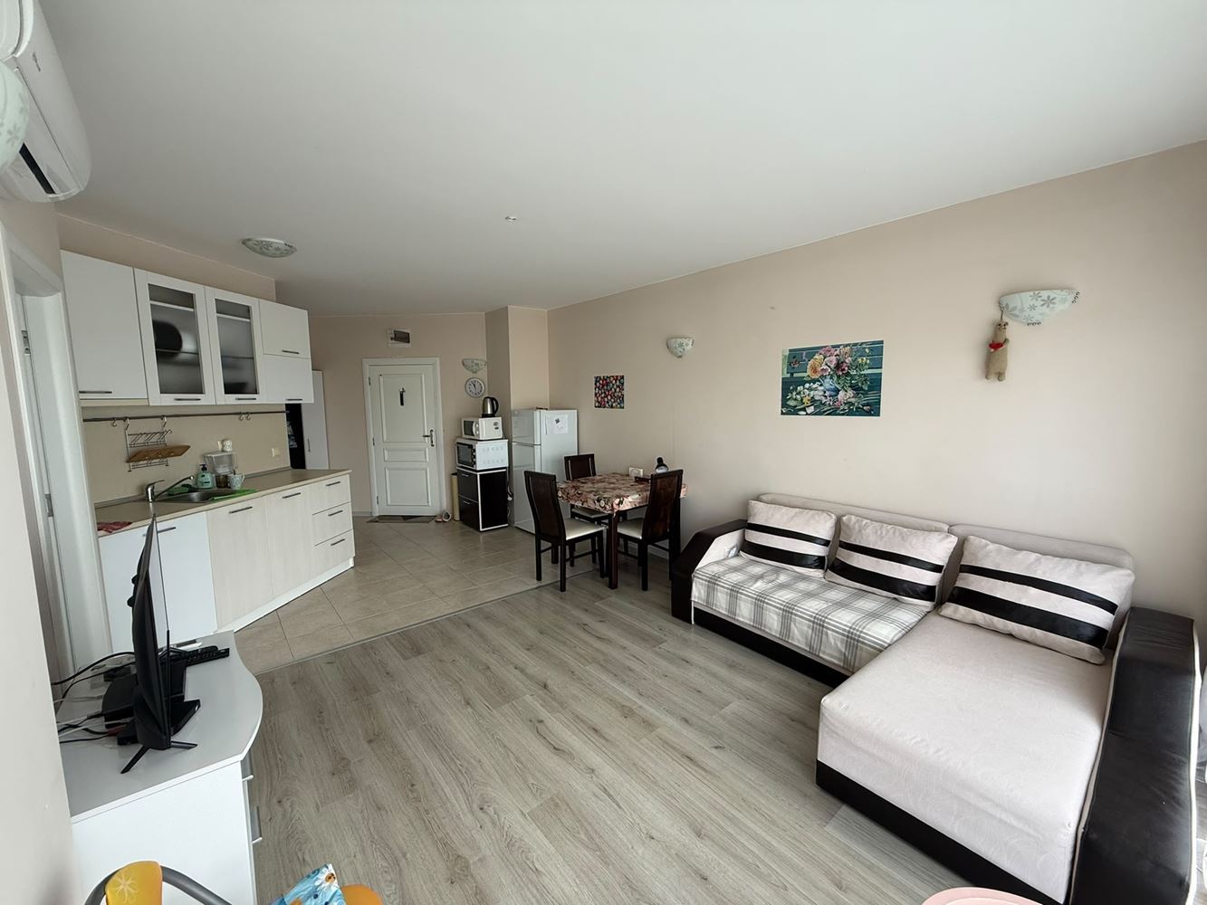 One-bedroom apartment surrounded by greenery in a complex with a swimming pool and children's playground