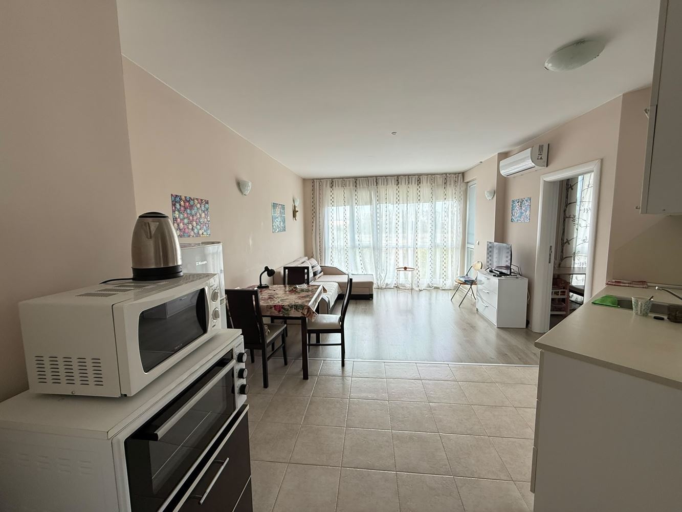 One-bedroom apartment surrounded by greenery in a complex with a swimming pool and children's playground