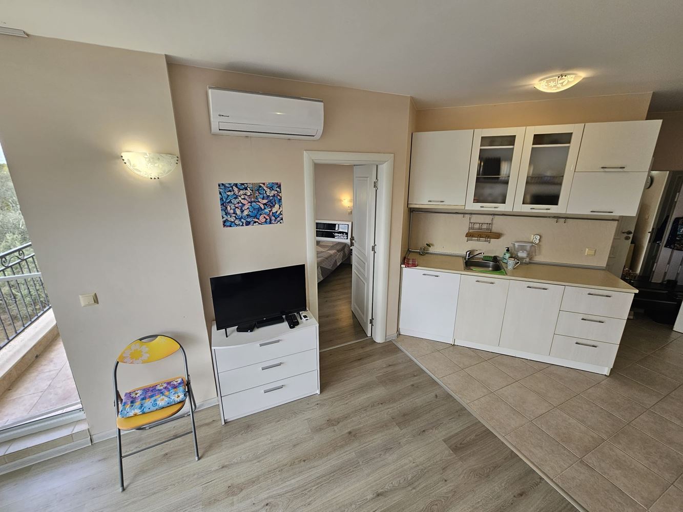 One-bedroom apartment surrounded by greenery in a complex with a swimming pool and children's playground