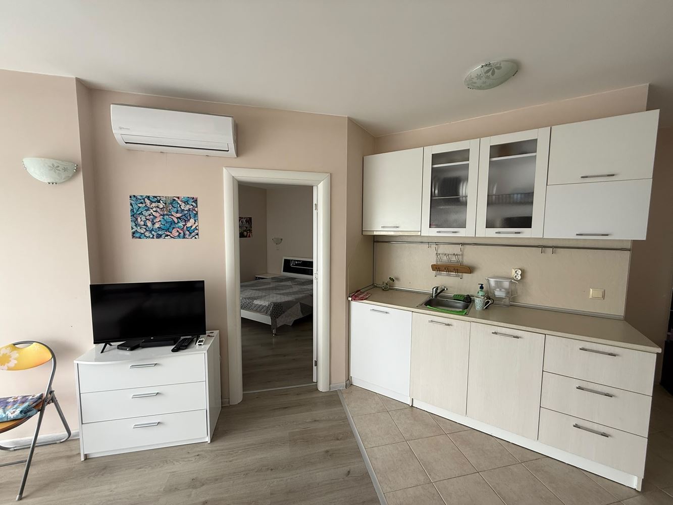 One-bedroom apartment surrounded by greenery in a complex with a swimming pool and children's playground