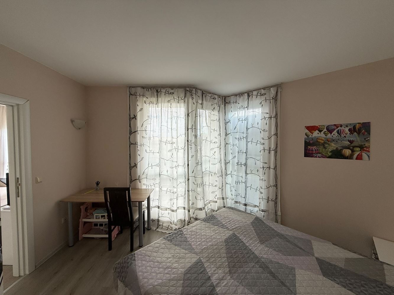One-bedroom apartment surrounded by greenery in a complex with a swimming pool and children's playground