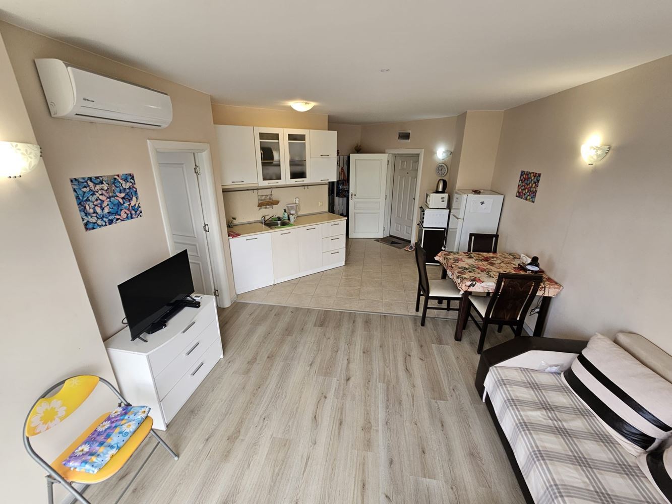 One-bedroom apartment surrounded by greenery in a complex with a swimming pool and children's playground