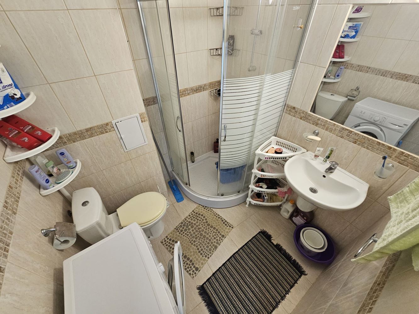 One-bedroom apartment surrounded by greenery in a complex with a swimming pool and children's playground